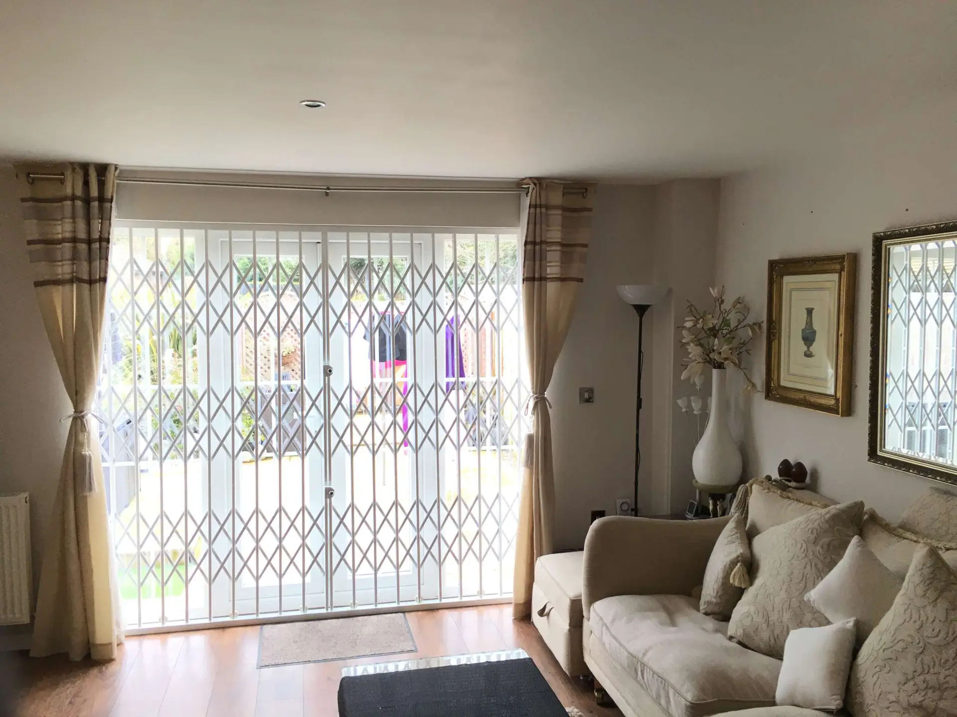 Living room with a security grille across patio doors